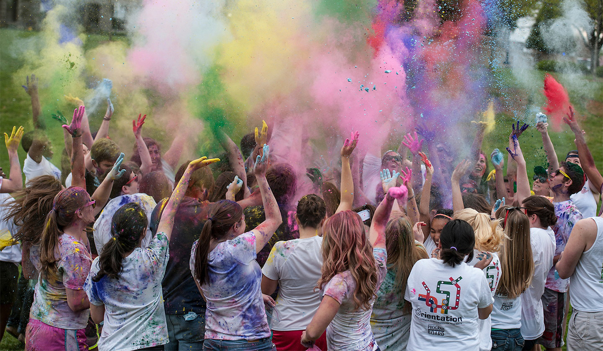 Students at the Color Fest covered in different color paint dust